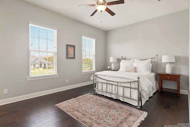 bedroom featuring baseboards, wood-type flooring, and ceiling fan