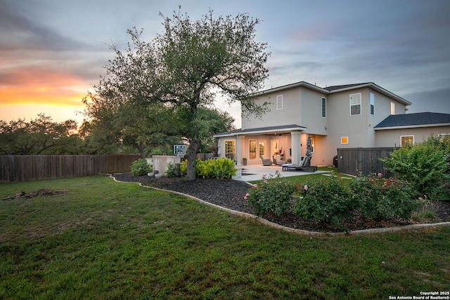back of house with a patio area and stucco siding