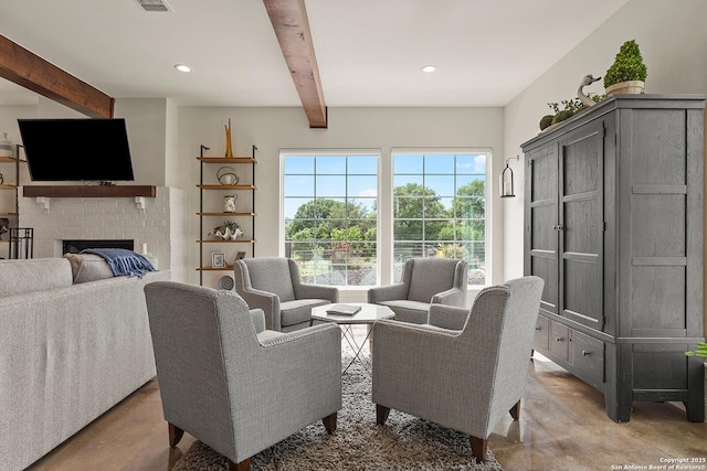 living room with concrete flooring, beamed ceiling, a fireplace, and recessed lighting
