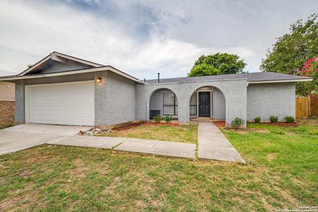 single story home featuring a garage and a front yard