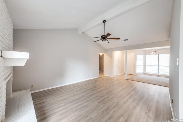 unfurnished living room with ceiling fan, wood-type flooring, a fireplace, and vaulted ceiling with beams