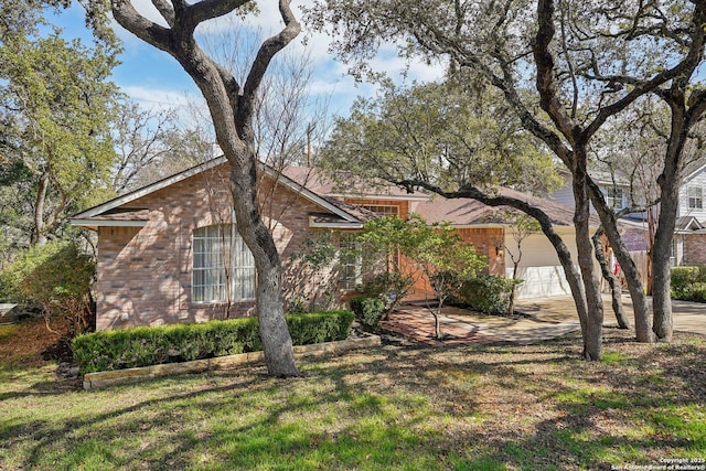 view of front of home featuring a garage and a front lawn