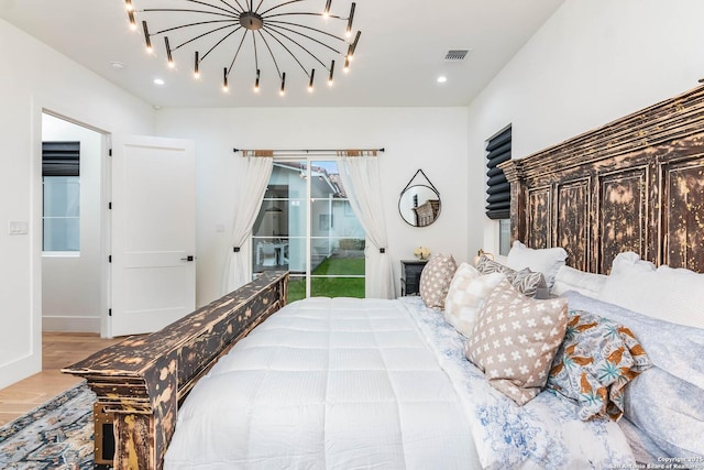 bedroom with access to exterior and light wood-type flooring