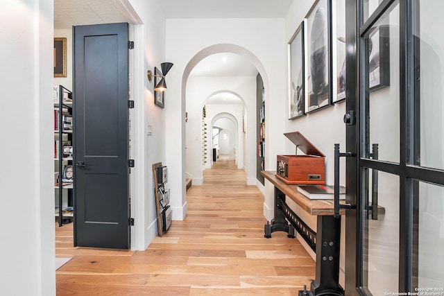 hallway with light hardwood / wood-style floors