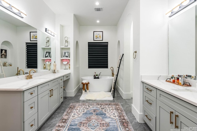 bathroom featuring vanity and a bath