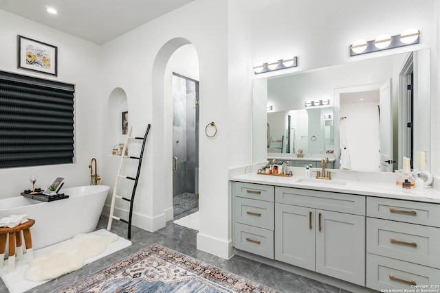 bathroom featuring vanity and separate shower and tub