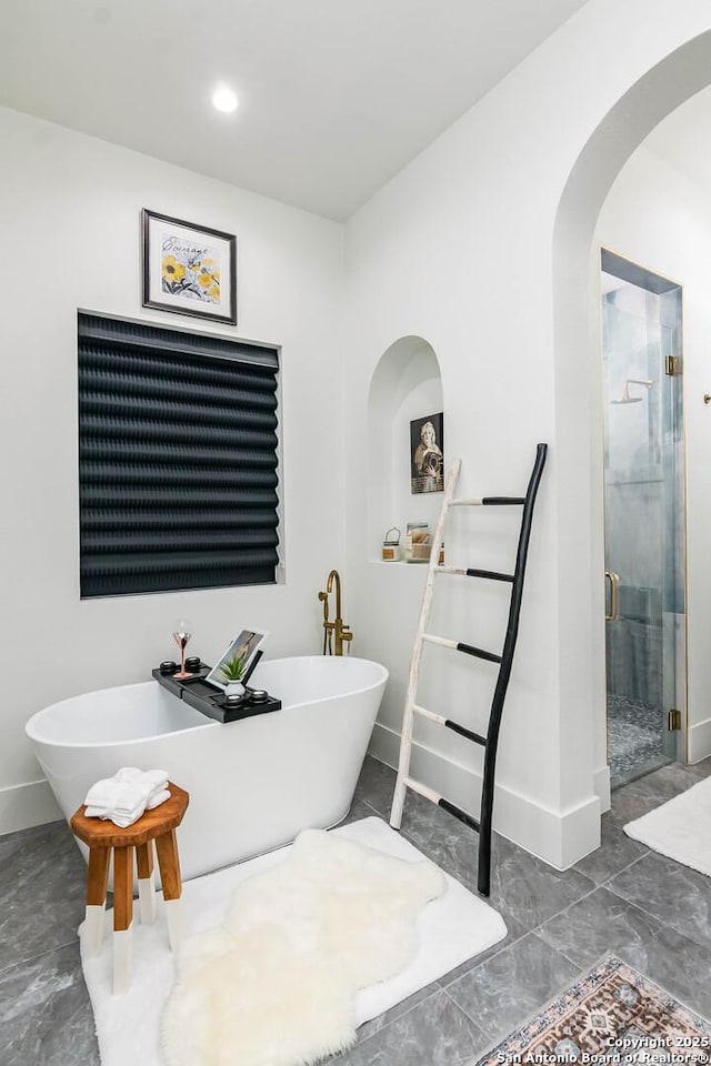 bathroom featuring separate shower and tub