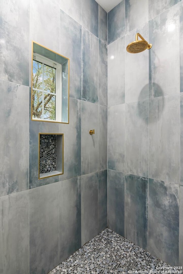 bathroom with tiled shower