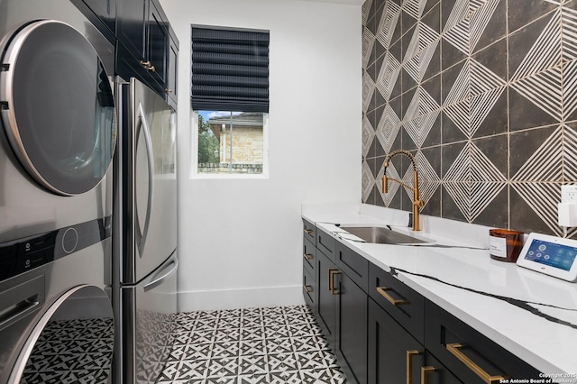 clothes washing area with sink and stacked washer / dryer