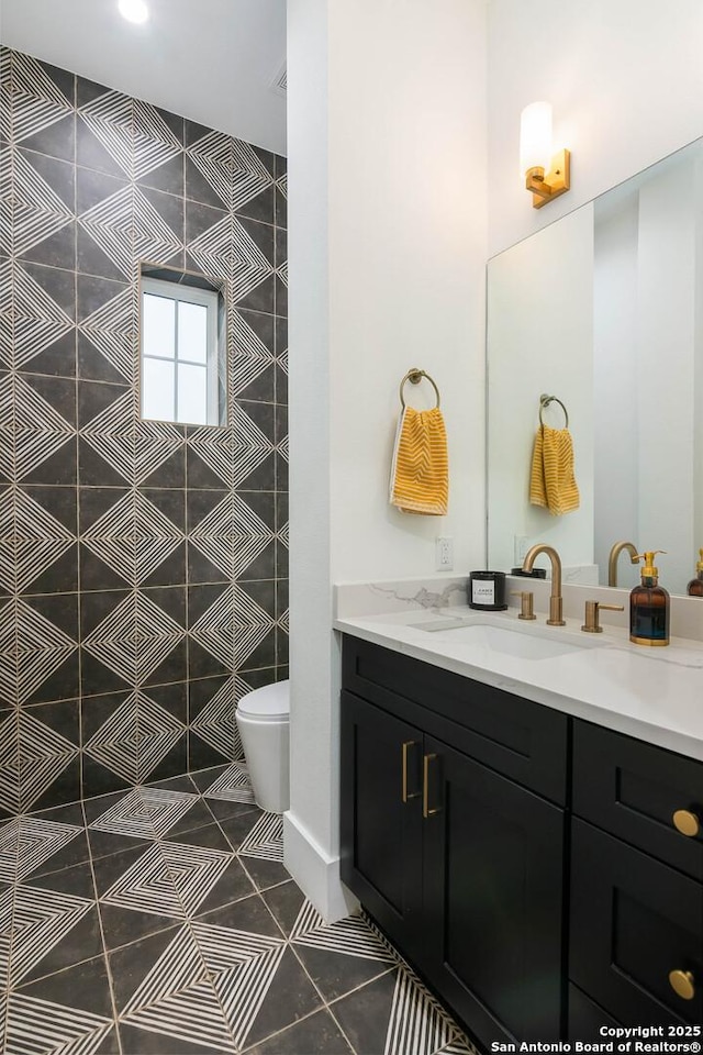 bathroom featuring vanity, tile patterned floors, and toilet