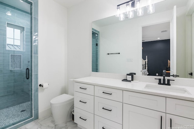 bathroom with vanity, toilet, and a shower with shower door