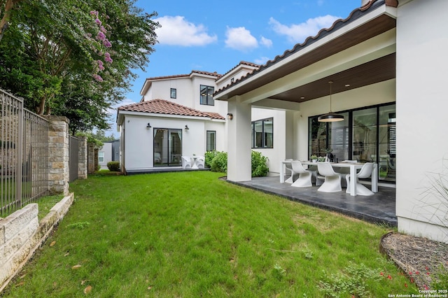 rear view of house featuring a yard, a patio area, and ceiling fan