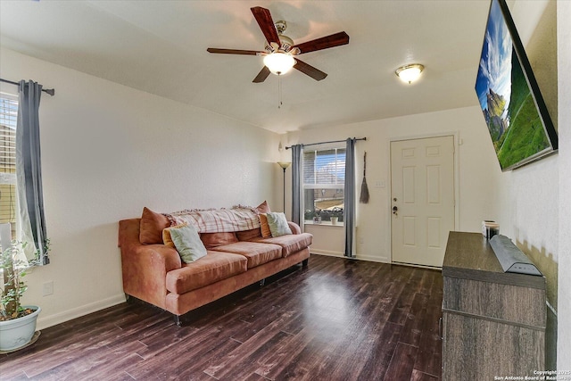 living room featuring ceiling fan and dark hardwood / wood-style floors