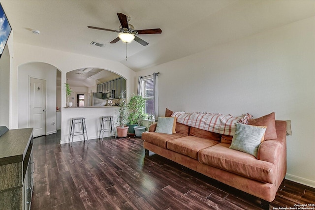 living room featuring dark wood-type flooring, ceiling fan, and lofted ceiling