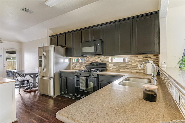 kitchen featuring dark hardwood / wood-style floors, sink, decorative backsplash, and black appliances