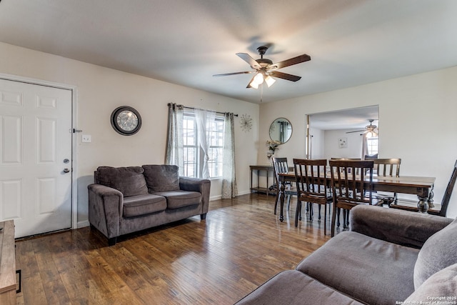 living room featuring dark hardwood / wood-style floors and ceiling fan