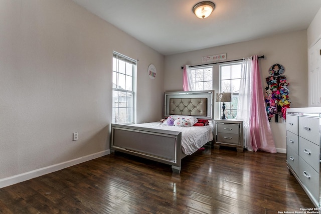 bedroom featuring dark hardwood / wood-style flooring and multiple windows