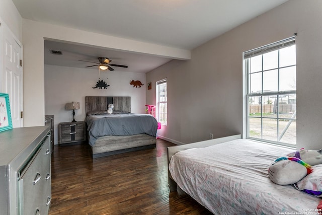 bedroom with beamed ceiling, ceiling fan, and dark hardwood / wood-style flooring