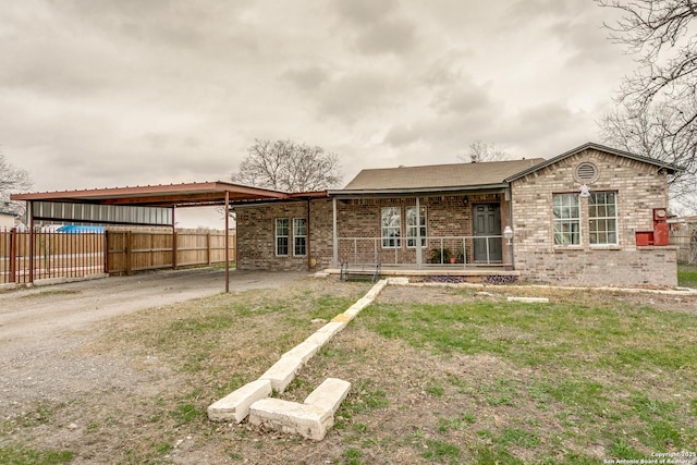 view of front of property with a carport and a front lawn