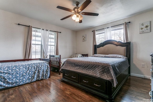 bedroom with dark wood-type flooring and ceiling fan