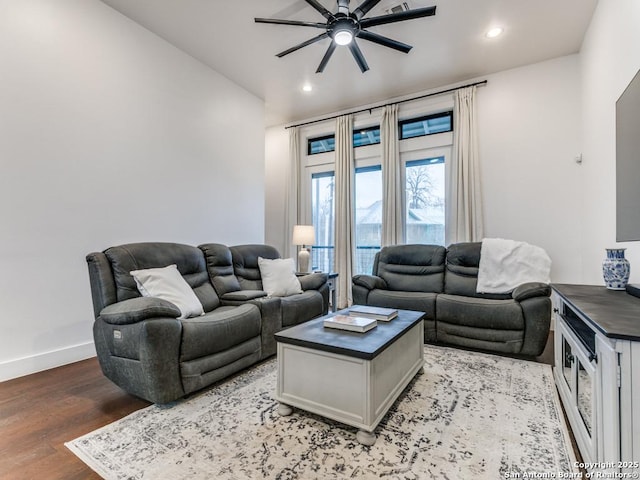 living room featuring light hardwood / wood-style flooring and ceiling fan