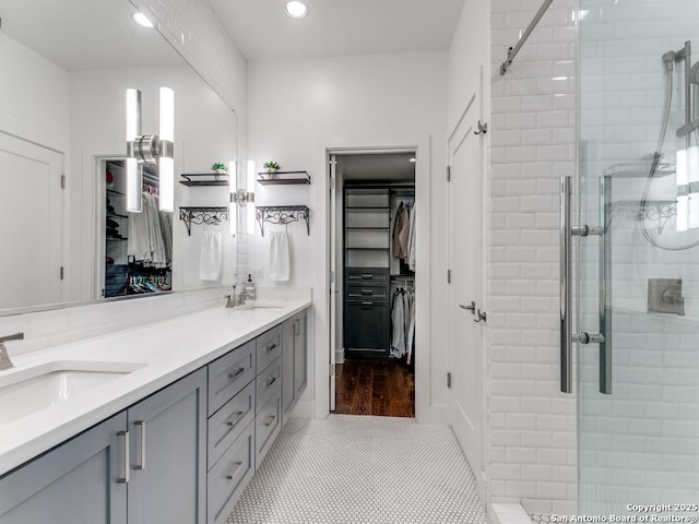 bathroom featuring vanity, tile patterned floors, and walk in shower