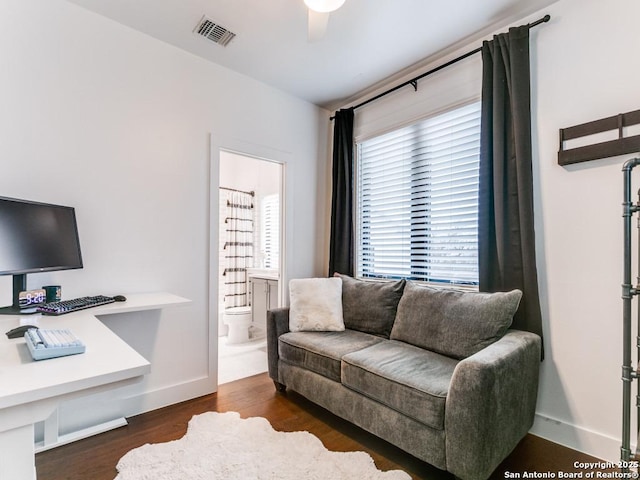 living room featuring ceiling fan and dark hardwood / wood-style flooring