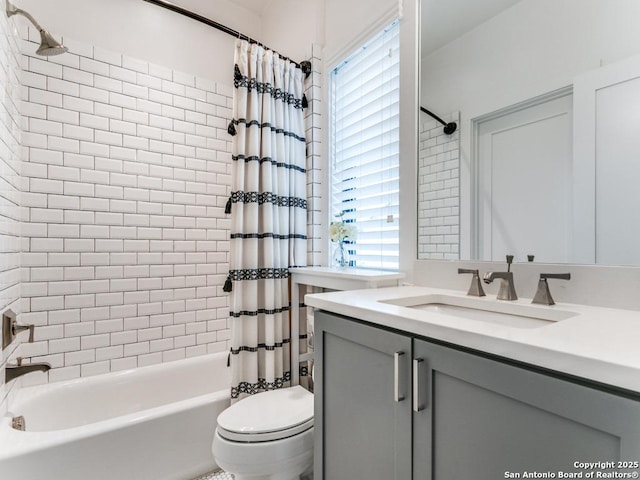 full bathroom with vanity, toilet, and shower / bath combo with shower curtain