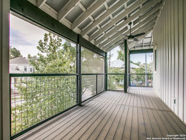 unfurnished sunroom with vaulted ceiling and ceiling fan