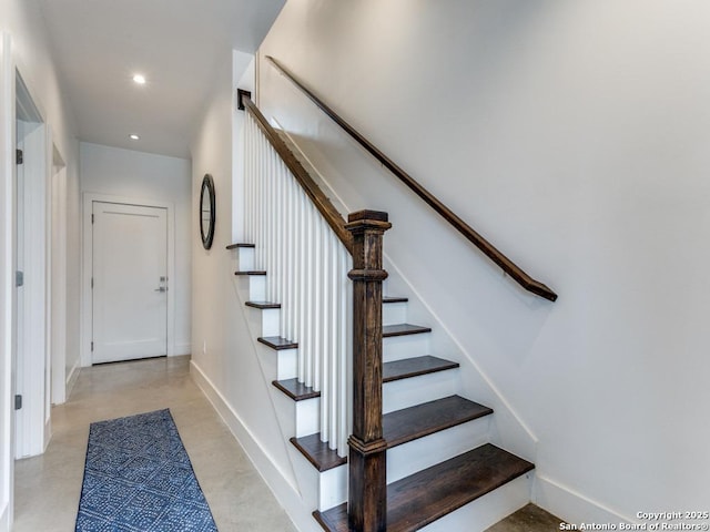 staircase with concrete floors