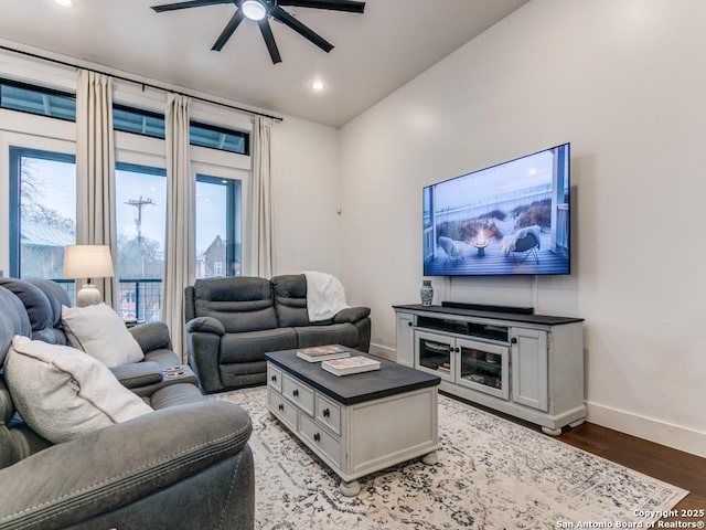 living room featuring wood-type flooring and ceiling fan