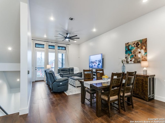 dining area with dark wood-type flooring and ceiling fan