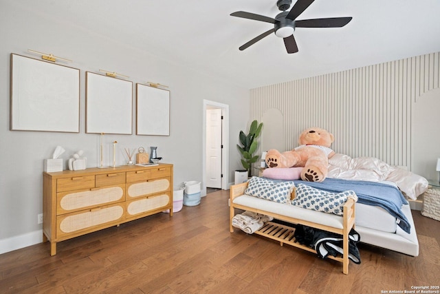 bedroom with ceiling fan and dark hardwood / wood-style flooring