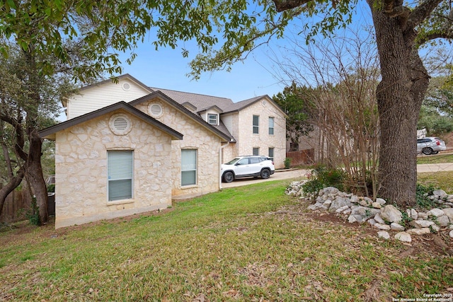 view of side of property with a lawn