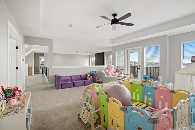 playroom featuring light carpet and ceiling fan