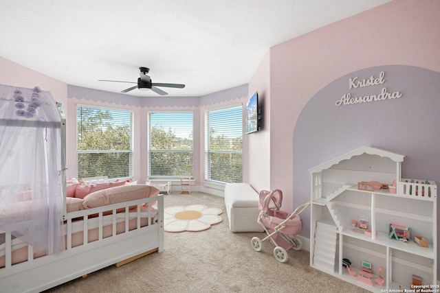 carpeted bedroom with ceiling fan and multiple windows