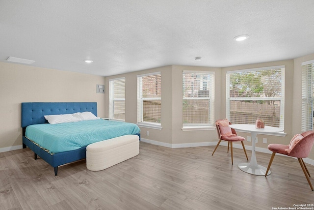 bedroom featuring a textured ceiling and light wood-type flooring