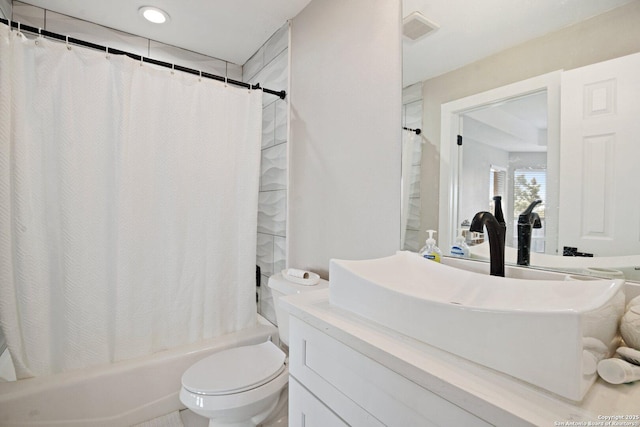 full bathroom featuring vanity, shower / bathtub combination with curtain, and toilet