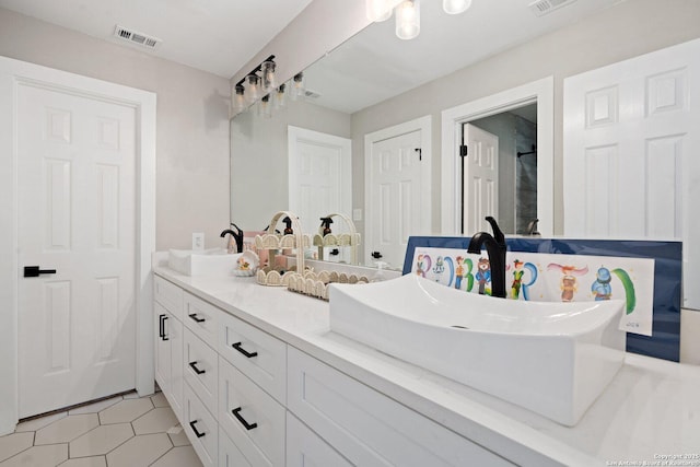 bathroom with tile patterned flooring and vanity