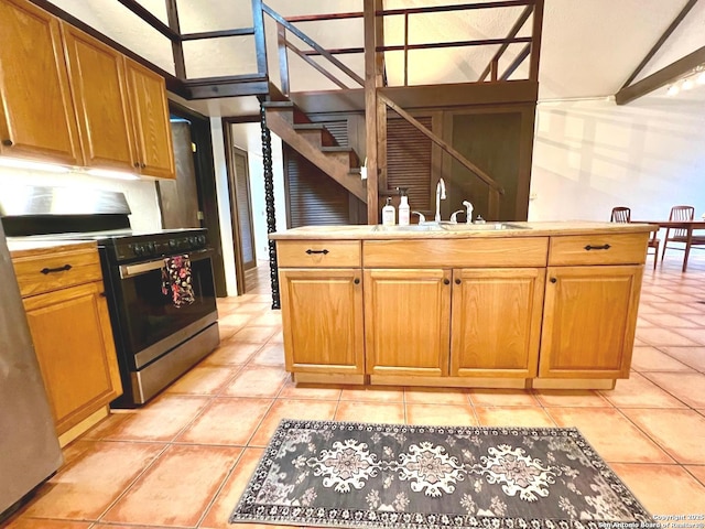 kitchen with sink, light tile patterned floors, and stainless steel electric range