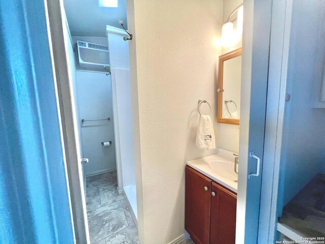 bathroom with vanity and a wall unit AC