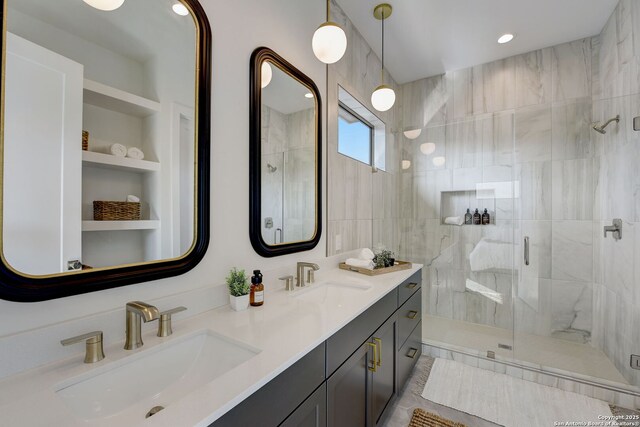 bathroom with vanity, built in shelves, tile walls, and a shower with shower door