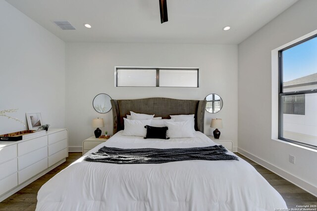 bedroom with ceiling fan and dark hardwood / wood-style flooring