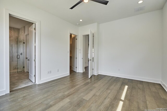 unfurnished bedroom with light hardwood / wood-style flooring, ceiling fan, and ensuite bathroom