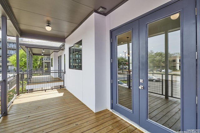 wooden deck with french doors and a water view