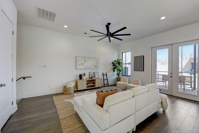 living room featuring dark hardwood / wood-style flooring, ceiling fan, french doors, and a healthy amount of sunlight