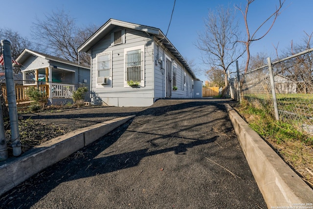 view of side of property with cooling unit and a porch