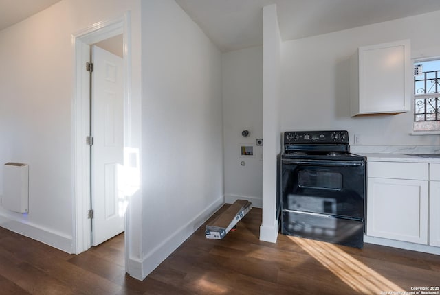 kitchen featuring black range with electric stovetop, dark hardwood / wood-style floors, and white cabinets