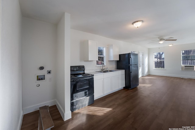 kitchen with white cabinetry, sink, cooling unit, and black appliances