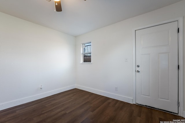 empty room with ceiling fan and dark hardwood / wood-style flooring